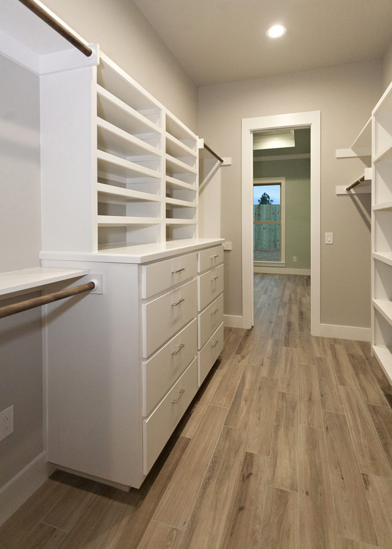 Reidy Modern Style Home Master Walkthrough Closet with built in cabinets and shelving