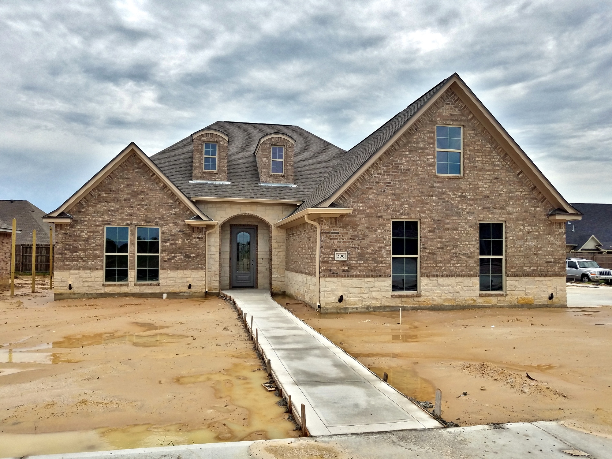 200 Hidden Grove Court front exterior with stone wrap brick above