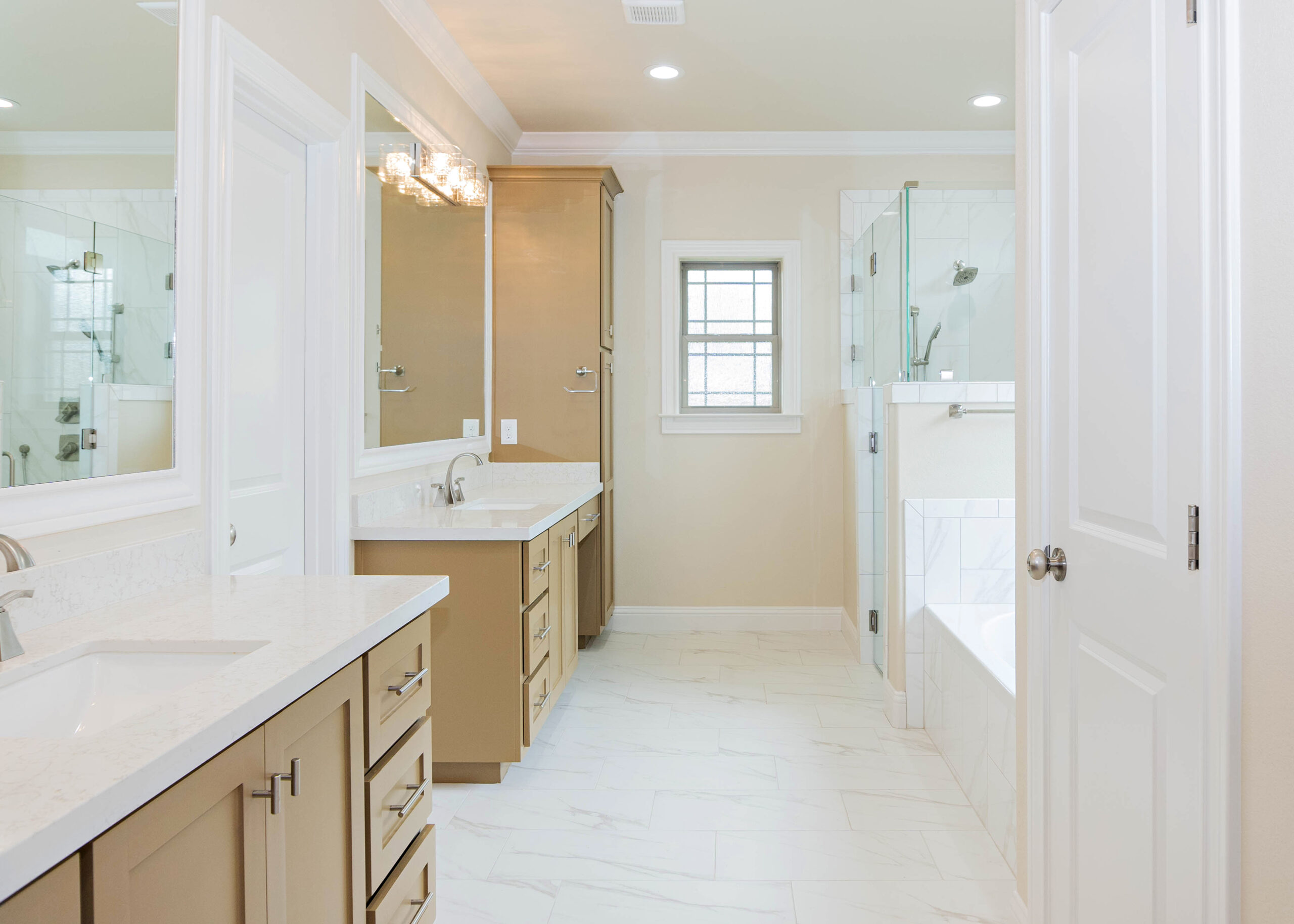240 Riverstone two story modern home master bathroom white tile flooring brown shaker style cabinets tile tube wrap built in tub