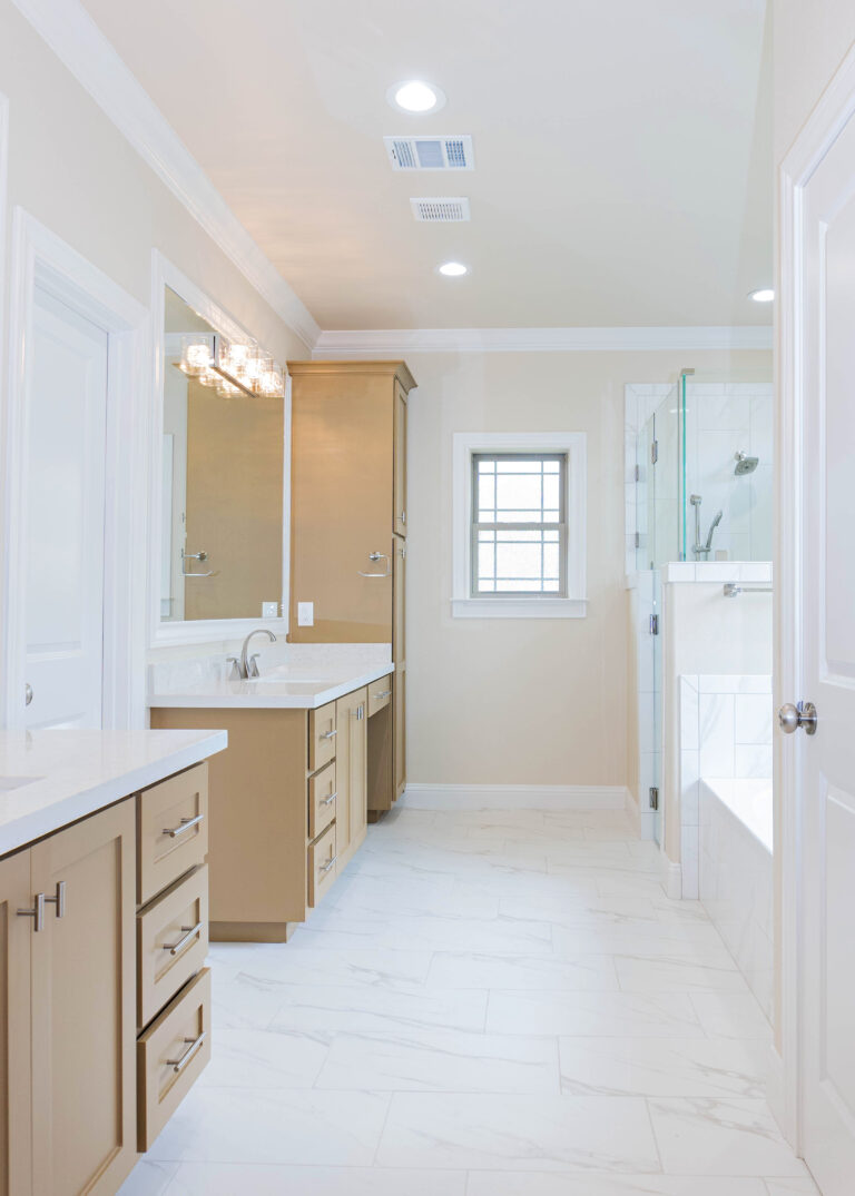 240 Riverstone two story modern home master bathroom white tile flooring brown shaker style cabinets tile tube wrap built in tub