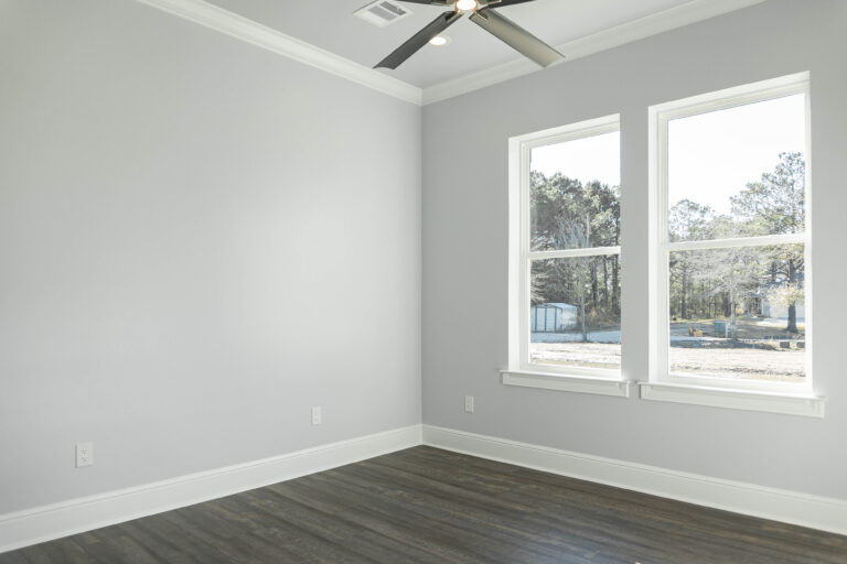 Boyt modern home guest bedroom brown wood look tile flooring white trim grey walls