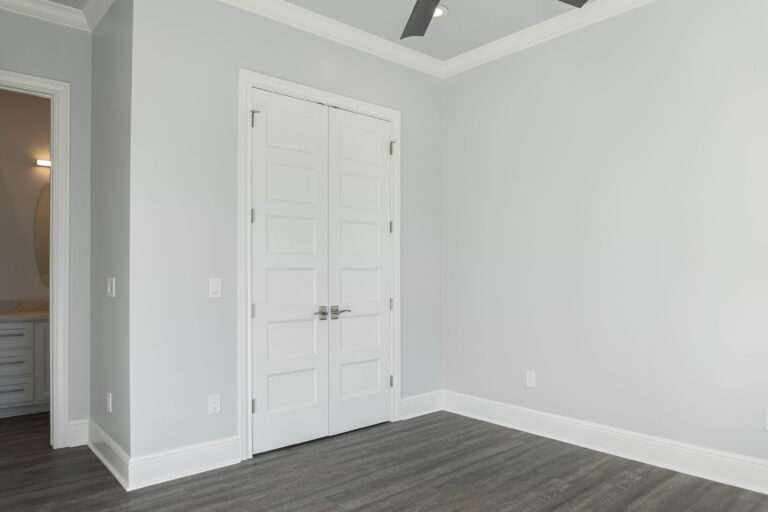 Boyt modern home guest bedroom brown wood look tile flooring white trim grey walls