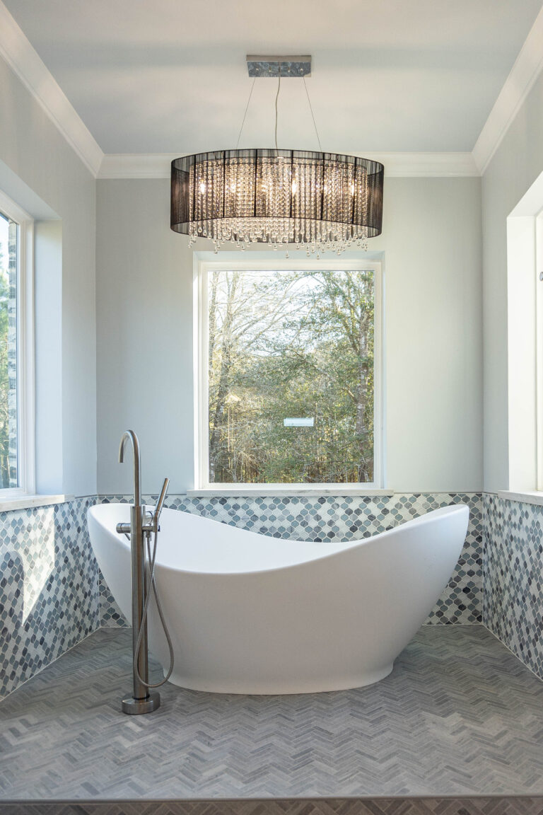 Boyt modern home master bathroom freestanding tub silver tub filler grey herringbone tile deck hexagonal backsplash modern chandelier