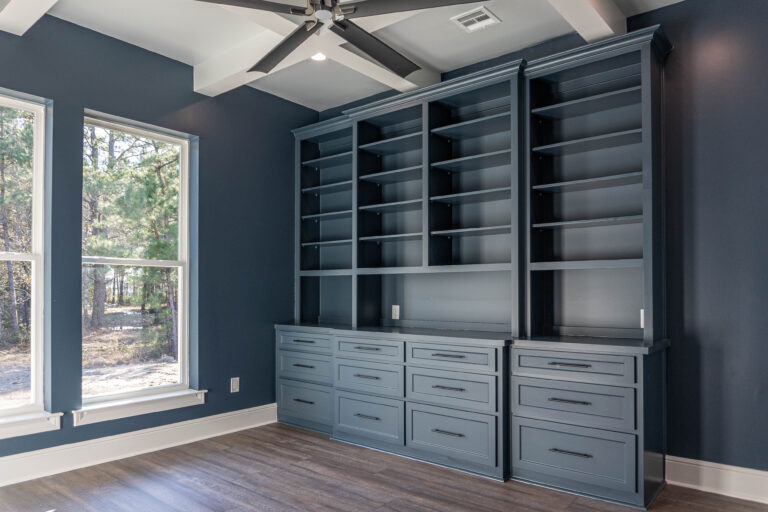 Boyt modern home study brown wood look tile blue built in shelving and cabinets white trim coffer ceiling