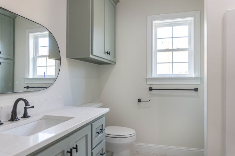 330 Hidden Grove home bathroom white tile green shaker style cabinets white counter tops brown hardware