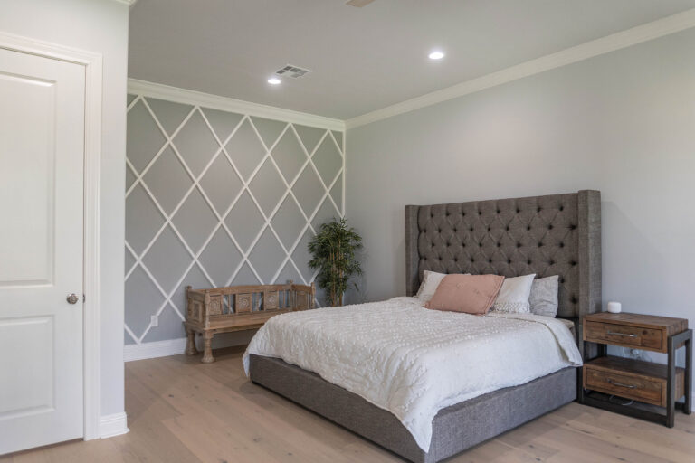 Esplanade Master Bedroom modern home tan wood look tile flooring grey walls white diamond trim decorative wall