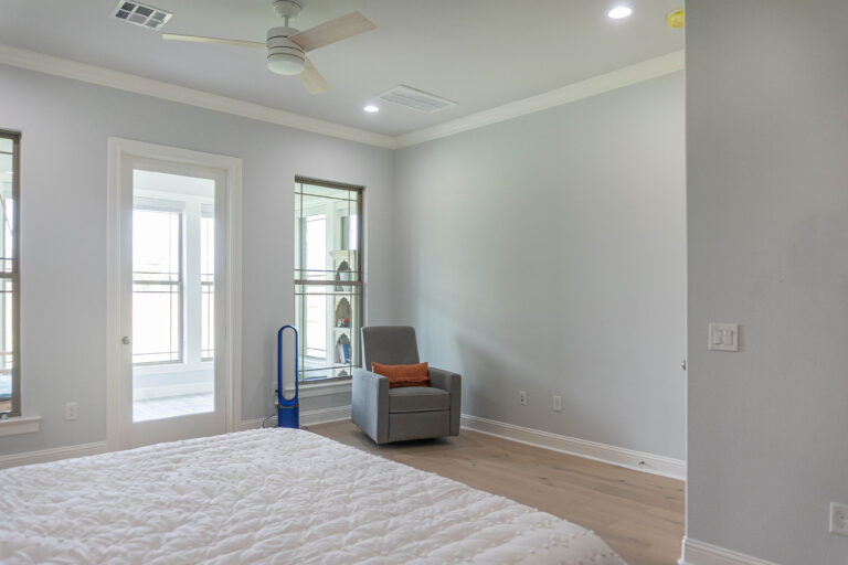 Esplanade modern home master bedroom tan wood look tile flooring grey walls sun room