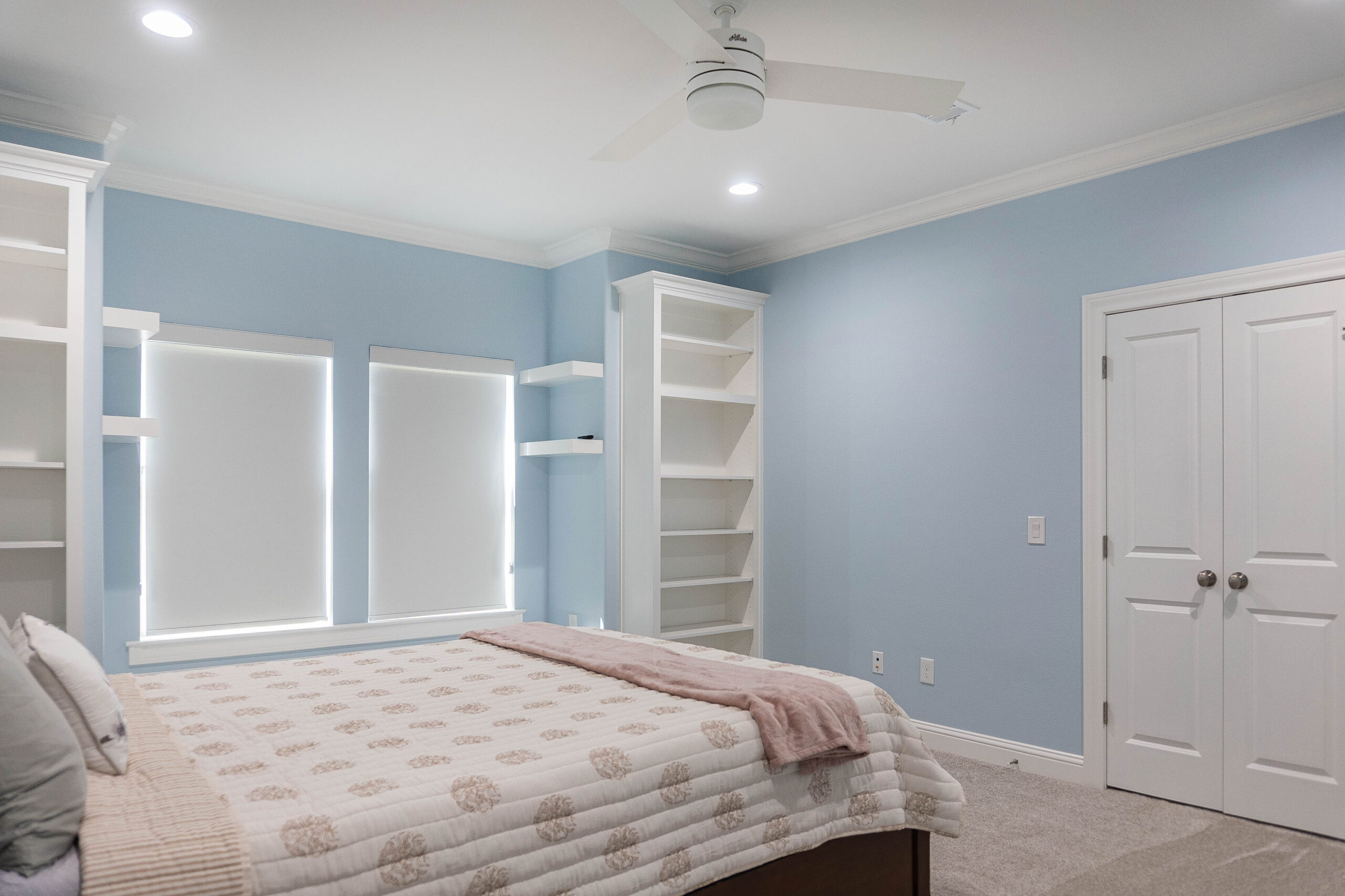Esplanade bedroom modern home tan carpet blue walls built in bookshelves white shaker cabinet window stool