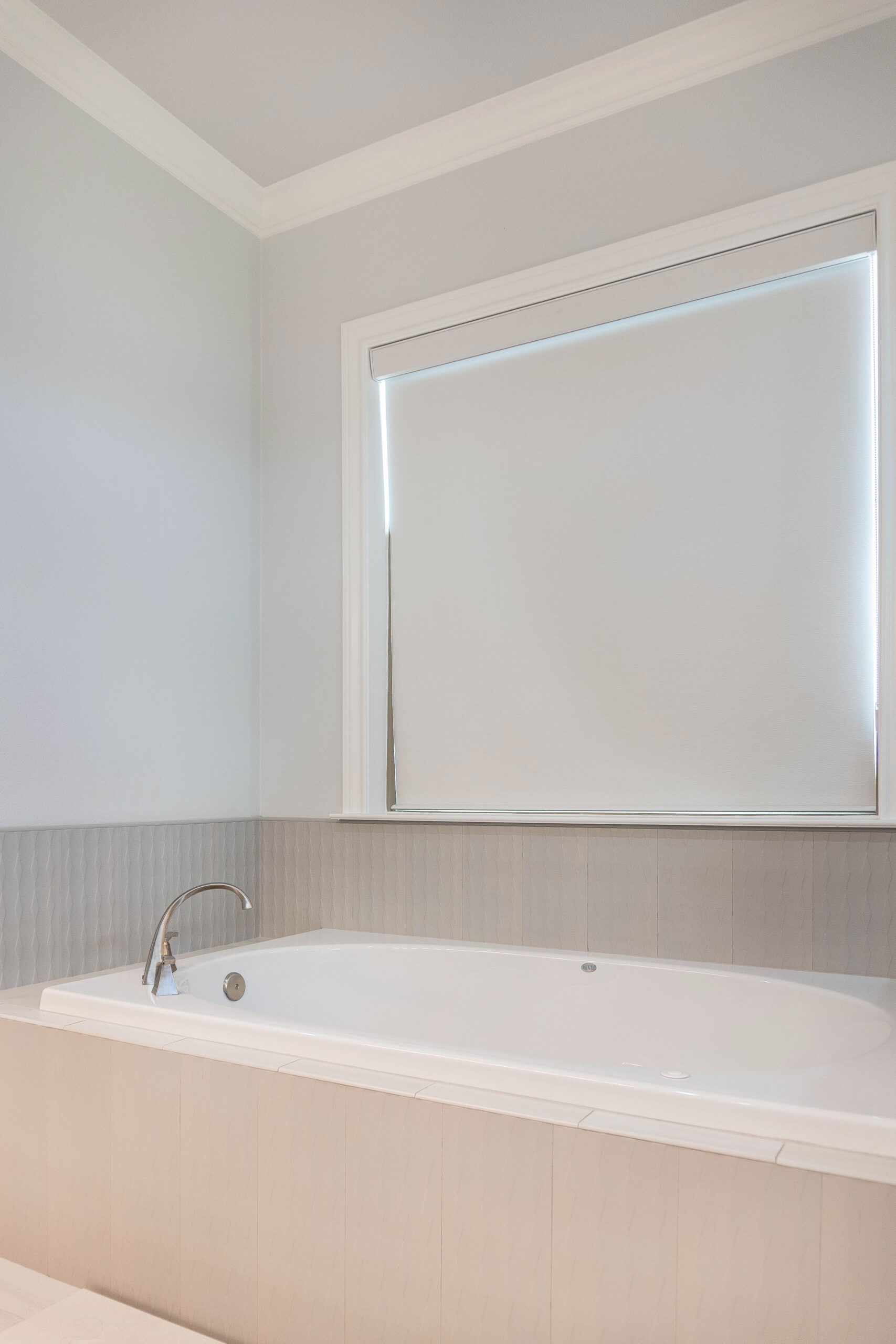 Esplanade modern home master bathroom built in tub with grey tile wrap and backsplash