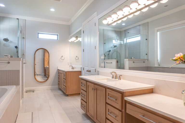 Esplanade modern home master bathroom white tile flooring natural wood stain shaker cabinet white marble counter tops