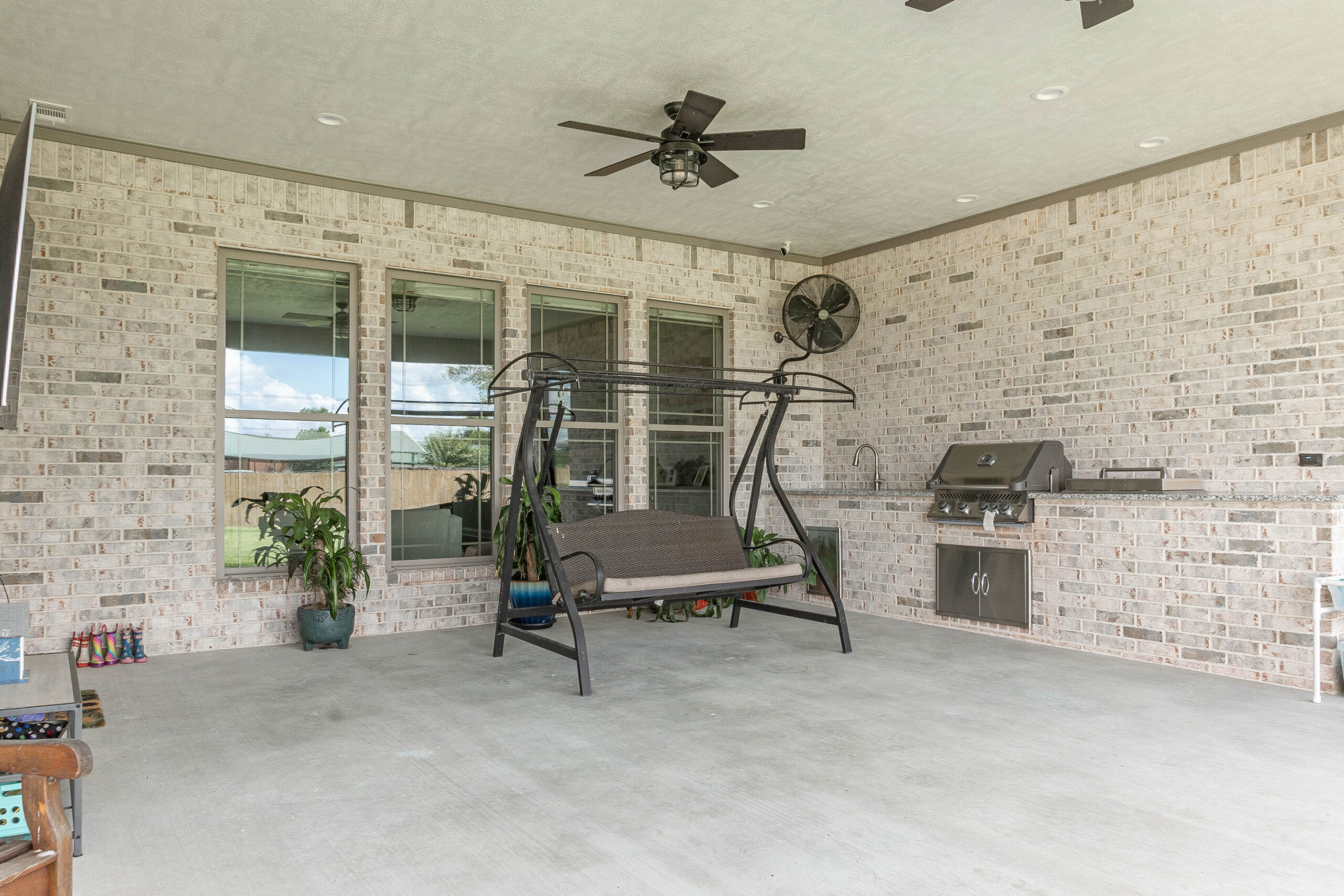 Esplanade Back Patio grey brick built in outdoor kitchen grill sink mounted wall fan Beaumont home builder