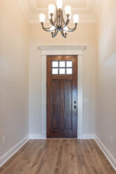 470 hidden grove court spec built home lumberton texas entry with hanging light stained entry door light brown wood flooring